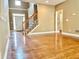 Inviting living room with hardwood floors, staircase and ample natural light at 100 Cottonwood Pl, Stockbridge, GA 30281