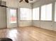 Bright sunroom featuring wood-look flooring, large windows, and a ceiling fan at 100 Cottonwood Pl, Stockbridge, GA 30281