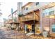 View of the back of townhomes with wood decks, awnings, and air conditioning units at 1605 Signal Flag Way, Lawrenceville, GA 30043