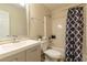 Cozy bathroom featuring modern vanity, toilet, and bathtub with shower featuring a decorative curtain at 1605 Signal Flag Way, Lawrenceville, GA 30043