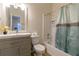 Bathroom with modern vanity, toilet, and bathtub with shower featuring a decorative shower curtain at 1605 Signal Flag Way, Lawrenceville, GA 30043