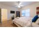 Bright bedroom with a ceiling fan, natural light, hardwood floors and closet at 1605 Signal Flag Way, Lawrenceville, GA 30043