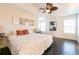 Bedroom featuring trey ceiling, wood floors, natural light, and comfortable bed with stylish pillows at 1605 Signal Flag Way, Lawrenceville, GA 30043