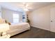 Bedroom featuring dark wood floors, a ceiling fan, and a comfortable bed with white linens at 1605 Signal Flag Way, Lawrenceville, GA 30043