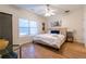 Bedroom featuring wood floors, a ceiling fan, and a comfortable bed with blue accent pillows at 1605 Signal Flag Way, Lawrenceville, GA 30043