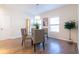 Inviting dining room with a chandelier, a glass table, and large windows providing ample natural light at 1605 Signal Flag Way, Lawrenceville, GA 30043