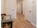 View of the entryway with hard wood floors, white walls, a small foyer table, and white doors at 1605 Signal Flag Way, Lawrenceville, GA 30043