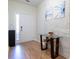 View of the entryway with hard wood floors, white walls, a small foyer table, and white doors at 1605 Signal Flag Way, Lawrenceville, GA 30043