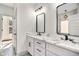 Modern bathroom featuring a double sink vanity with marble countertop and black hardware at 3900 Arbor Se Ln, Conyers, GA 30094