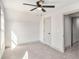 Spacious bedroom featuring plush carpet, a ceiling fan and a doorway with a view to the hallway at 3900 Arbor Se Ln, Conyers, GA 30094