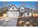 Beautiful new two-story home with fresh landscaping, a modern farmhouse design, and a concrete driveway at 3900 Arbor Se Ln, Conyers, GA 30094