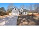 Two-story farmhouse features a white exterior, gray roof, and attached garage at 3900 Arbor Se Ln, Conyers, GA 30094