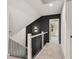 Second floor hallway featuring a carpet, wainscoting detail, and a white-painted staircase at 3900 Arbor Se Ln, Conyers, GA 30094