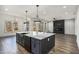 Spacious kitchen showcases a large island, modern lighting, and an adjacent fireplace at 3900 Arbor Se Ln, Conyers, GA 30094