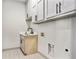 Functional laundry room featuring cabinets, a sink, and patterned tile flooring at 3900 Arbor Se Ln, Conyers, GA 30094