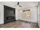 Cozy living room with wood flooring, a modern fireplace, and a large window with a serene outdoor view at 3900 Arbor Se Ln, Conyers, GA 30094