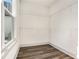 Spacious walk-in closet featuring hardwood floors, wire shelves, and a natural light-filled window at 3900 Arbor Se Ln, Conyers, GA 30094