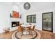 Dining area with fireplace, modern table and chairs, and view into back yard at 113 Kathryn Ave, Decatur, GA 30030