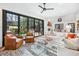 Sun-drenched living room with modern furniture, fireplace, and large sliding doors to backyard patio at 113 Kathryn Ave, Decatur, GA 30030