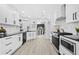 Modern kitchen with white shaker cabinets, black countertops, and stainless steel appliances at 5727 Bonnell Ct, Rex, GA 30273