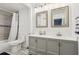 Stylish bathroom featuring dual sinks, mirrors, and a combined shower-tub at 1403 Parkaire Xing, Marietta, GA 30068