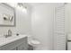 Bright bathroom featuring a modern vanity, toilet, and white paneled doors at 1403 Parkaire Xing, Marietta, GA 30068