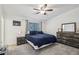 Relaxing main bedroom featuring a ceiling fan, plush carpet, and ample natural light at 1403 Parkaire Xing, Marietta, GA 30068