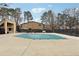 Community pool covered in tarp, surrounded by spacious concrete and neighboring buildings at 1403 Parkaire Xing, Marietta, GA 30068