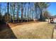 Expansive backyard featuring trees, shed, and patio with pergola, ideal for entertaining at 3710 Blackgold Dr, Buford, GA 30519