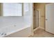 Bathroom featuring a garden tub with tile surround and a glass shower enclosure at 3710 Blackgold Dr, Buford, GA 30519