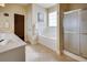 Bathroom with a tiled floor, a white tub, glass-enclosed shower, and a double sink vanity at 3710 Blackgold Dr, Buford, GA 30519