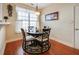 Cozy breakfast nook featuring a dark wood table, chandelier and a bright window at 3710 Blackgold Dr, Buford, GA 30519