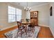 Charming dining room featuring a wooden table, chandelier and large window at 3710 Blackgold Dr, Buford, GA 30519