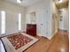 Inviting entryway with hardwood floors, a patterned rug, and a classic wooden cabinet at 3710 Blackgold Dr, Buford, GA 30519