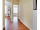 Hallway with gleaming hardwood floors offering views into rooms with natural light at 3710 Blackgold Dr, Buford, GA 30519