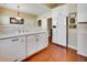 Modern kitchen with white cabinetry, backsplash, and stainless steel dishwasher at 3710 Blackgold Dr, Buford, GA 30519