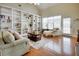 Bright living room with built-in bookshelves, hardwood floors, and a comfortable seating area at 3710 Blackgold Dr, Buford, GA 30519