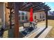 Outdoor patio with a pergola, seating and red umbrella offers a shady outdoor retreat at 3710 Blackgold Dr, Buford, GA 30519