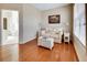 Sitting room featuring a cushioned wicker trunk table, sitting sofa, and hardwood floors at 3710 Blackgold Dr, Buford, GA 30519