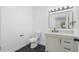 Simple bathroom with single vanity and dark tile floors at 4280 Atlanta St, Powder Springs, GA 30127