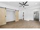 Bedroom with barn doors, hardwood floors, and access to bathroom at 4280 Atlanta St, Powder Springs, GA 30127