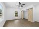 Bedroom with barn doors and ceiling fan at 4280 Atlanta St, Powder Springs, GA 30127