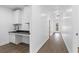 Long hallway with wood-look floors and access to other rooms at 4280 Atlanta St, Powder Springs, GA 30127