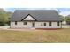 Rear view of modern farmhouse with gray roof and large yard at 4280 Atlanta St, Powder Springs, GA 30127