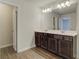 Double vanity bathroom with dark brown cabinets at 4351 Portsbrook Ave, Snellville, GA 30039