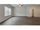 Spacious bedroom with hardwood floors, large window, and an attached bathroom at 4351 Portsbrook Ave, Snellville, GA 30039