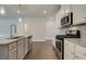 Modern kitchen with white cabinets, granite countertops and stainless steel appliances at 4351 Portsbrook Ave, Snellville, GA 30039