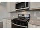 Stainless steel appliances and granite countertops in this modern kitchen at 4351 Portsbrook Ave, Snellville, GA 30039