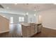 Kitchen island with granite countertop and modern pendant lighting at 4351 Portsbrook Ave, Snellville, GA 30039