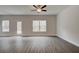 Open living area with hardwood floors, access to backyard, and multiple windows at 4351 Portsbrook Ave, Snellville, GA 30039